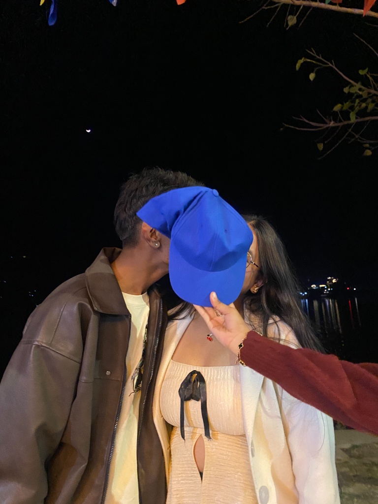 kiss under cap at night